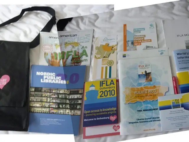 In the picture there is a bag and some books on a bed. On the bag it was written library lovers.