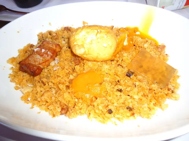 In this picture there is a food on the plate. There are plates and there is a spoon, bottle and box...